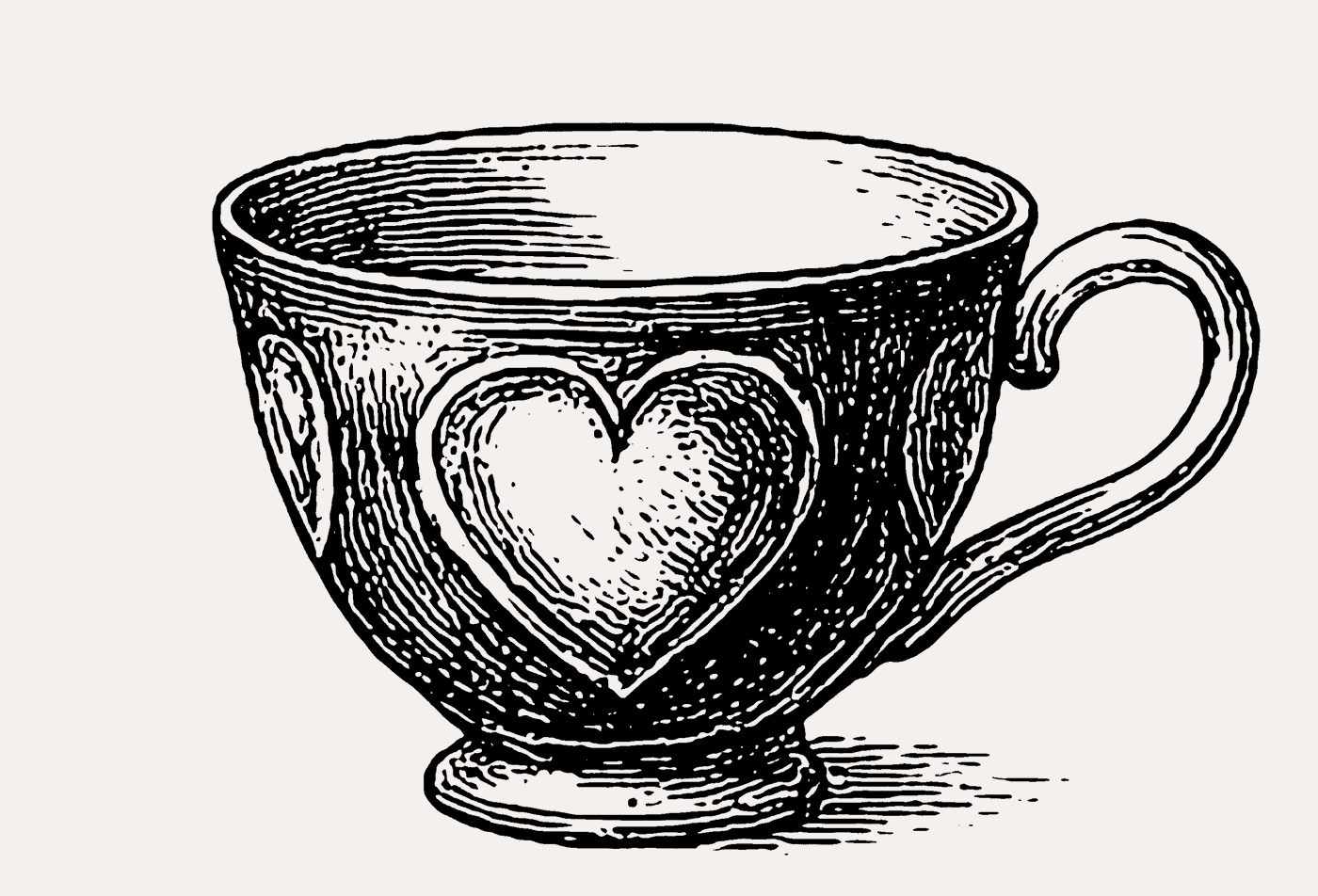 Engraved teacup with heart motif.